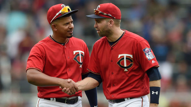 MINNEAPOLIS, MN - JUNE 24: Eduardo Escobar #5 and Brian Dozier #2 of the Minnesota Twins celebrate defeating the Texas Rangers after the game on June 24, 2018 at Target Field in Minneapolis, Minnesota. The Twins defeated the Rangers 2-0.