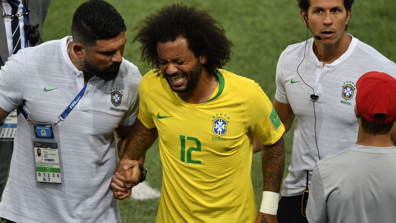 Brazil's defender Marcelo (C) reacts after getting injured during the Russia 2018 World Cup Group E football match between Serbia and Brazil at the Spartak Stadium in Moscow on June 27, 2018.