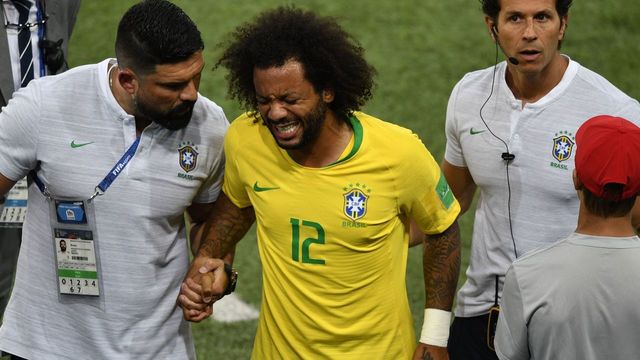 Brazil's defender Marcelo (C) reacts after getting injured during the Russia 2018 World Cup Group E football match between Serbia and Brazil at the Spartak Stadium in Moscow on June 27, 2018.