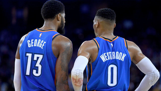 OAKLAND, CA - FEBRUARY 06: Paul George #13 and Russell Westbrook #0 of the Oklahoma City Thunder looks on against the Golden State Warriors during the second half of their NBA basketball game at ORACLE Arena on February 6, 2018 in Oakland, California.