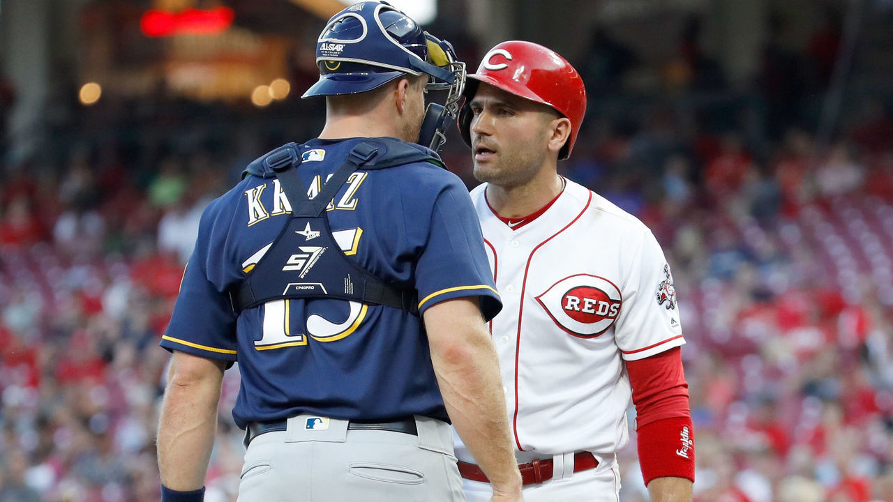 CINCINNATI, OH - JUNE 28: Joey Votto #19 of the Cincinnati Reds and Erik Kratz #15 of the Milwaukee Brewers exchange words during the third inning at Great American Ball Park on June 28, 2018 in Cincinnati, Ohio.