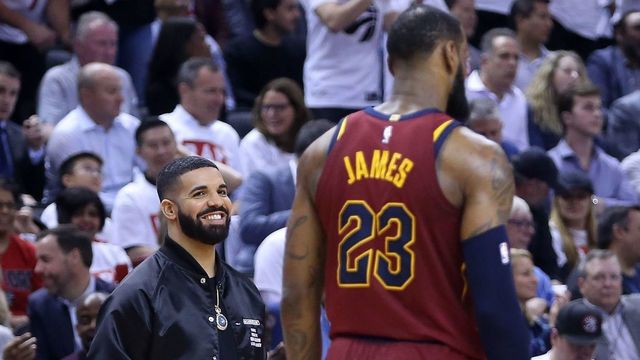 TORONTO, ON - MAY 01: Rapper Drake smiles at LeBron James #23 of the Cleveland Cavaliers in the second half of Game One of the Eastern Conference Semifinals against the Toronto Raptors during the 2018 NBA Playoffs at Air Canada Centre on May 1, 2018 in Toronto, Canada.