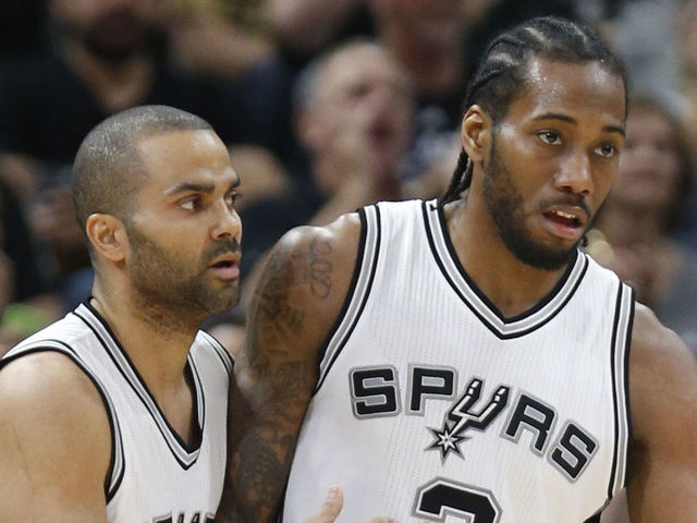 SAN ANTONIO,TX - MARCH 15: Tony Parker #9 of the San Antonio Spurs congratulates Kawhi Leonard #2 of the San Antonio Spurs after three against the Los Angeles Clippers at AT&T Center on March 15, 2016 in San Antonio, Texas. NOTE TO USER: User expressly acknowledges and agrees that , by downloading and or using this photograph, User is consenting to the terms and conditions of the Getty Images License Agreement.