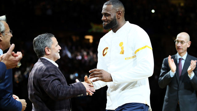 CLEVELAND, OH - OCTOBER 25: LeBron James #23 of the Cleveland Cavaliers recieves his championship ring from owner Dan Gilbert before the game against the New York Knicks at Quicken Loans Arena on October 25, 2016 in Cleveland, Ohio.
