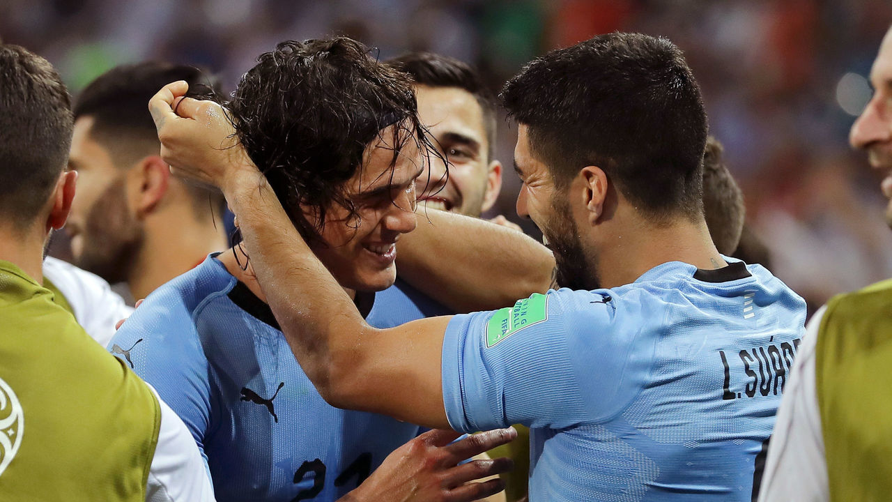 SOCHI, RUSSIA - JUNE 30: Edinson Cavani of Uruguay celebrates with teammate Luis Suarez after scoring his team's second goal during the 2018 FIFA World Cup Russia Round of 16 match between Uruguay and Portugal at Fisht Stadium on June 30, 2018 in Sochi, Russia.