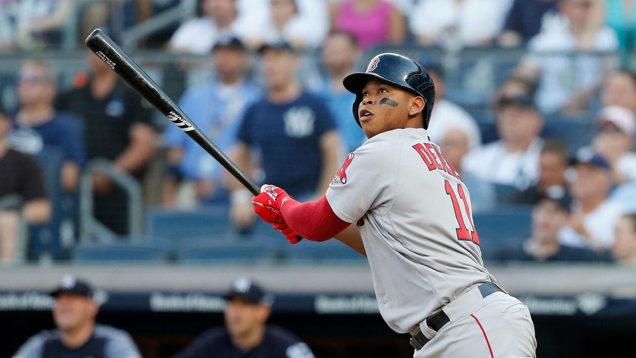 NEW YORK, NY - JUNE 30: Rafael Devers #11 of the Boston Red Sox follows through on a first inning grand slam home run against the New York Yankees at Yankee Stadium on June 30, 2018 in the Bronx borough of New York City.