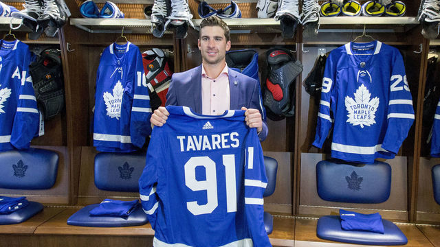 TORONTO, ON - JULY 1 - Tavares posing with his jersey in the Leafs locker room. The Toronto Maple Leafs have signed John Tavares for seven years, $77 million. July 1, 2018. (Carlos Osorio/Toronto Star via Getty Images)