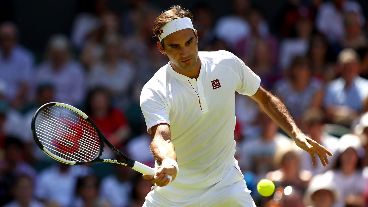 LONDON, ENGLAND - JULY 02: Roger Federer of Switzerland returns to Dusan Lajovic of Serbia during their Men's Singles first round match on day one of the Wimbledon Lawn Tennis Championships at All England Lawn Tennis and Croquet Club on July 2, 2018 in London, England.