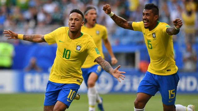 Brazil's forward Neymar (L) celebrates after scoring the opening goal during the Russia 2018 World Cup round of 16 football match between Brazil and Mexico at the Samara Arena in Samara on July 2, 2018.