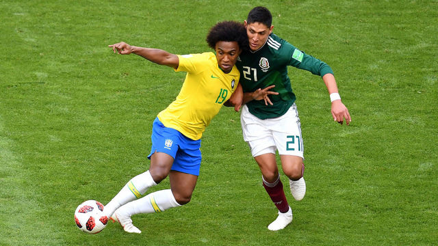 SAMARA, RUSSIA - JULY 02: Willian of Brazil battles for possession with Edson Alvarez of Mexico during the 2018 FIFA World Cup Russia Round of 16 match between Brazil and Mexico at Samara Arena on July 2, 2018 in Samara, Russia.