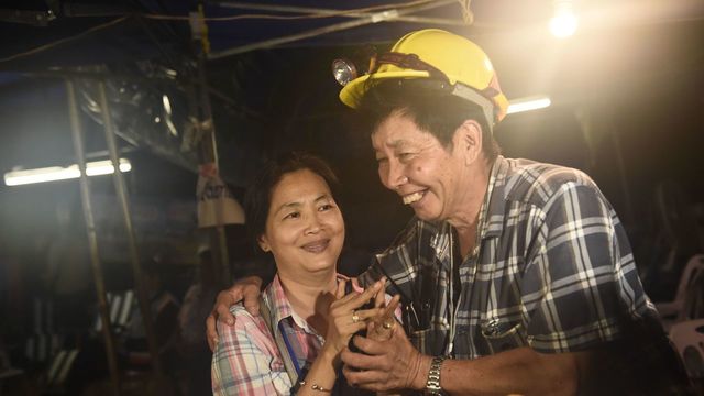 Family members of one of the missing boy celebrate while camping out near Than Luang cave following news all members of children's football team and their coach were alive in the cave at Khun Nam Nang Non Forest Park in the Mae Sai district of Chiang Rai province late July 2, 2018. - Twelve boys and their football coach trapped in a flooded Thai cave for nine days were 'found safe' late July 2, in a miracle rescue after days of painstaking searching by divers.