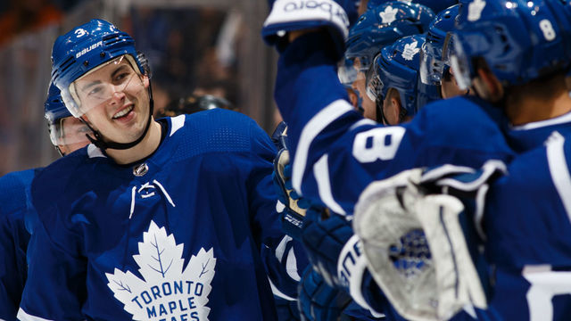 TORONTO, ON - JANUARY 31: Justin Holl #3 of the Toronto Maple Leafs is congratulated by teammates after scoring his first NHL goal against the New York Islanders during the third period at the Air Canada Centre on January 31, 2018 in Toronto, Ontario, Canada.