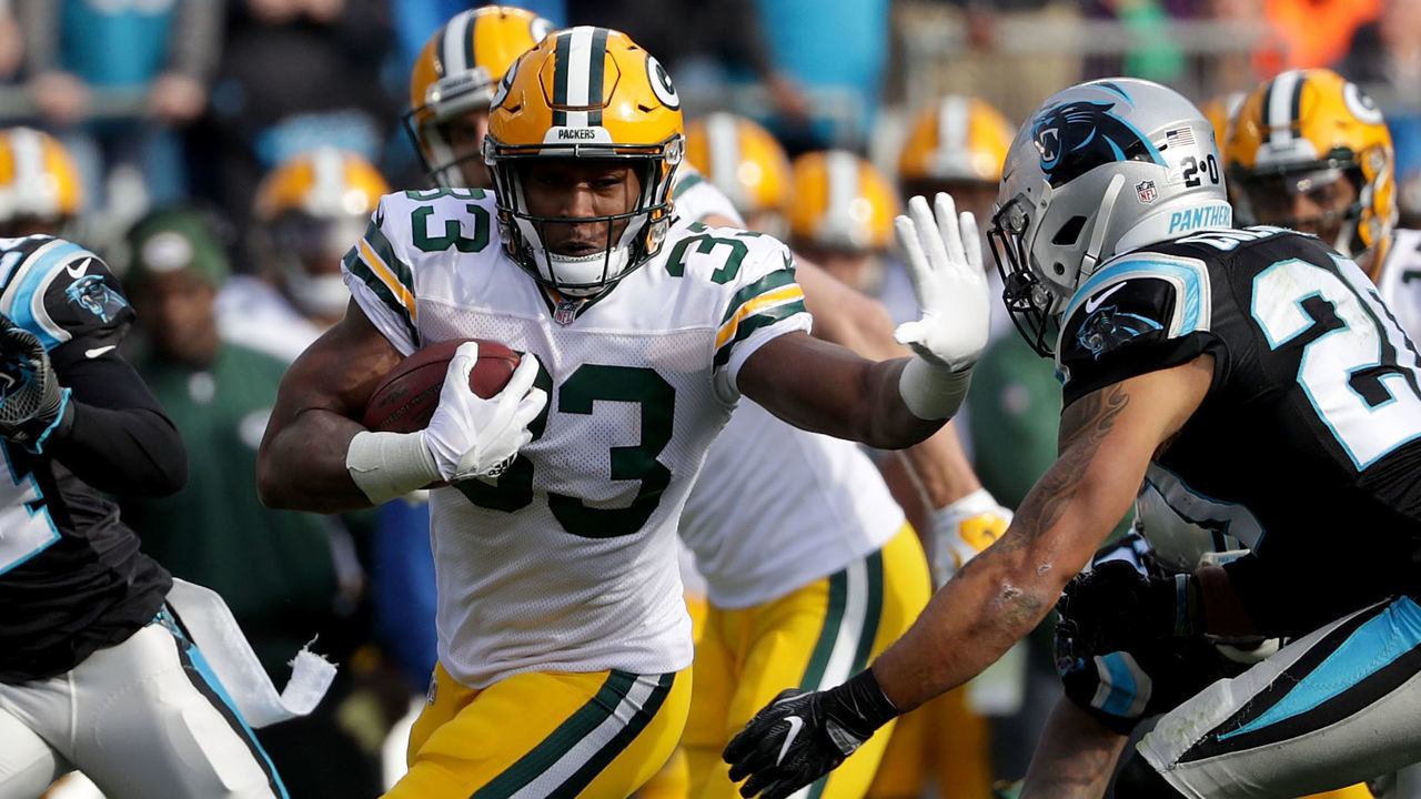CHARLOTTE, NC - DECEMBER 17: Aaron Jones #33 of the Green Bay Packers runs the ball against the Carolina Panthers in the second quarter during their game at Bank of America Stadium on December 17, 2017 in Charlotte, North Carolina.