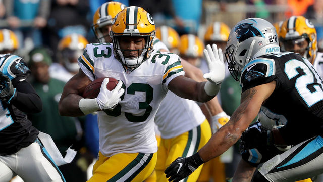 CHARLOTTE, NC - DECEMBER 17: Aaron Jones #33 of the Green Bay Packers runs the ball against the Carolina Panthers in the second quarter during their game at Bank of America Stadium on December 17, 2017 in Charlotte, North Carolina.