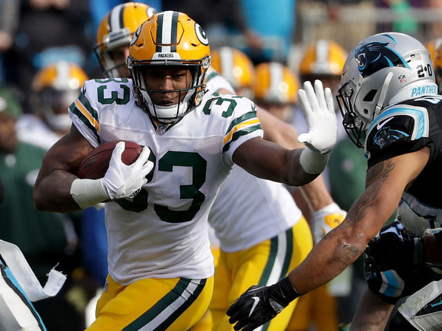 CHARLOTTE, NC - DECEMBER 17: Aaron Jones #33 of the Green Bay Packers runs the ball against the Carolina Panthers in the second quarter during their game at Bank of America Stadium on December 17, 2017 in Charlotte, North Carolina.