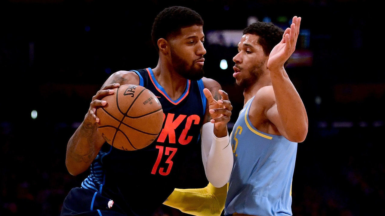 LOS ANGELES, CA - JANUARY 03: Paul George #13 of the Oklahoma City Thunder drives on Josh Hart #5 of the Los Angeles Lakers during the first half at Staples Center on January 3, 2018 in Los Angeles, California.