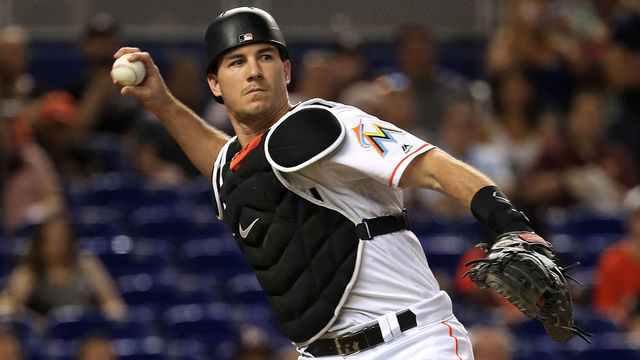 MIAMI, FL - JULY 27: J.T. Realmuto #11 of the Miami Marlins makes a throw to first during a game against the Cincinnati Reds at Marlins Park on July 27, 2017 in Miami, Florida.