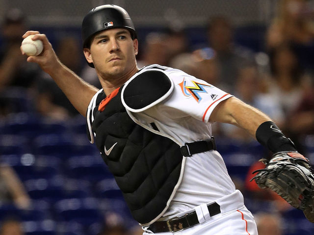 MIAMI, FL - JULY 27: J.T. Realmuto #11 of the Miami Marlins makes a throw to first during a game against the Cincinnati Reds at Marlins Park on July 27, 2017 in Miami, Florida.