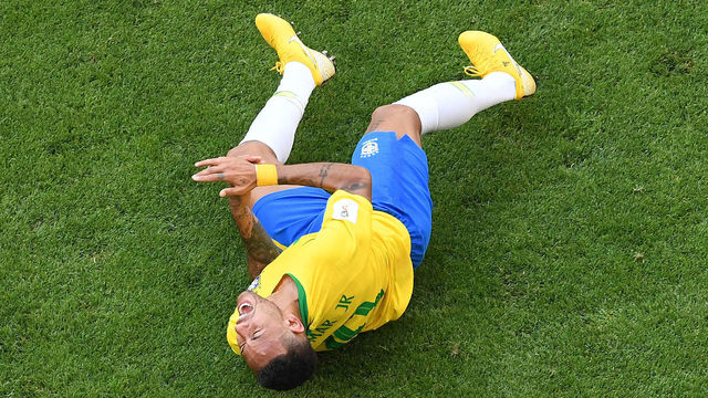 Brazil's forward Neymar reacts on the ground after being fouled during the Russia 2018 World Cup round of 16 football match between Brazil and Mexico at the Samara Arena in Samara on July 2, 2018.