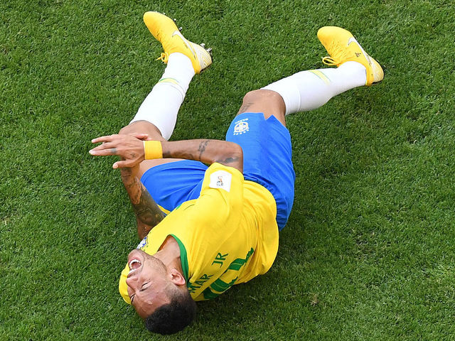 Brazil's forward Neymar reacts on the ground after being fouled during the Russia 2018 World Cup round of 16 football match between Brazil and Mexico at the Samara Arena in Samara on July 2, 2018.