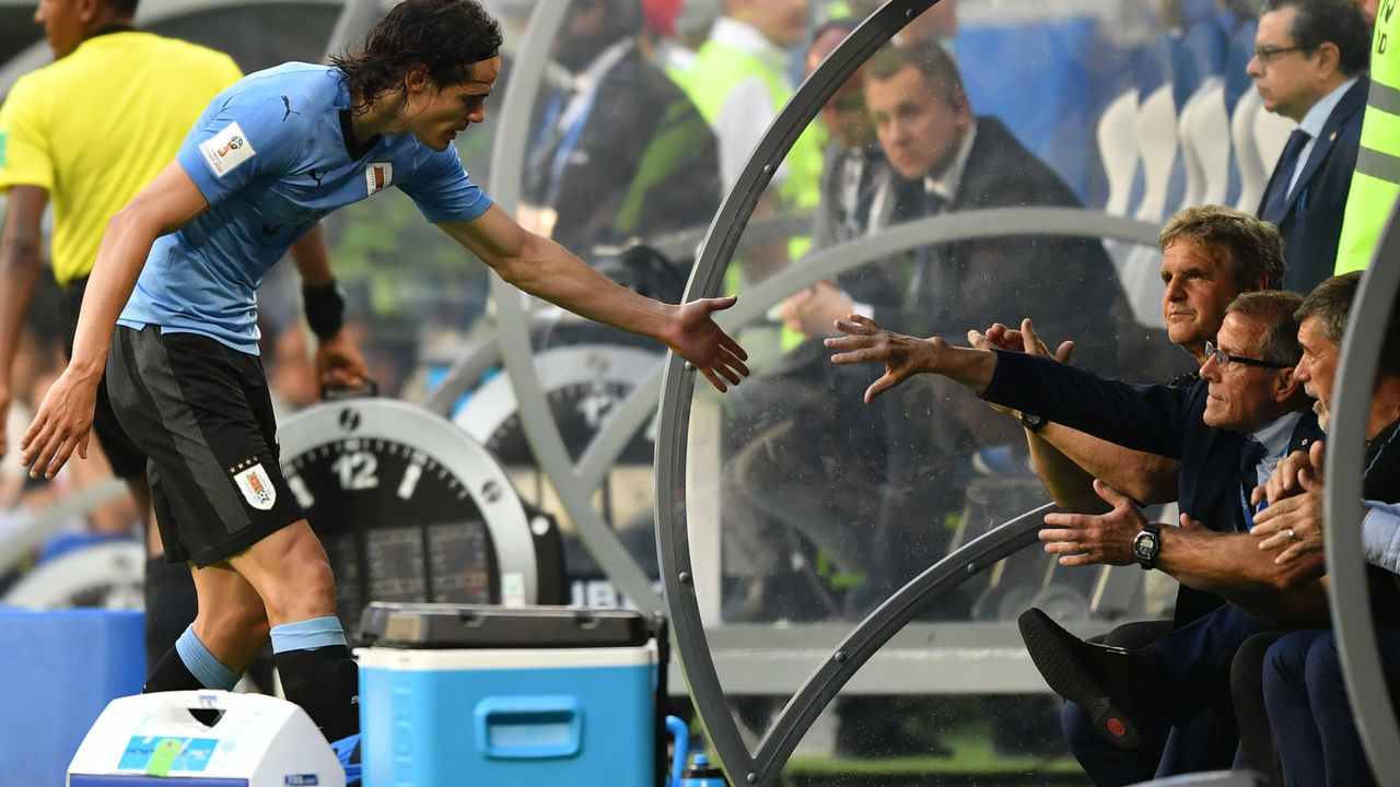 Uruguay's forward Edinson Cavani (L) celebrates with Uruguay's coach Oscar Washington Tabarez at the end of the Russia 2018 World Cup Group A football match between Uruguay and Russia at the Samara Arena in Samara on June 25, 2018.