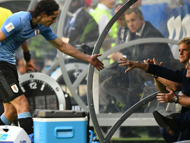 Uruguay's forward Edinson Cavani (L) celebrates with Uruguay's coach Oscar Washington Tabarez at the end of the Russia 2018 World Cup Group A football match between Uruguay and Russia at the Samara Arena in Samara on June 25, 2018.