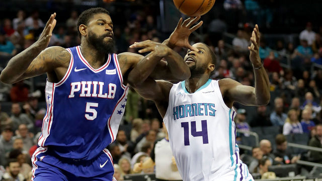 CHARLOTTE, NC - MARCH 06: Michael Kidd-Gilchrist #14 of the Charlotte Hornets goes after a loose ball against Amir Johnson #5 of the Philadelphia 76ers during their game at Spectrum Center on March 6, 2018 in Charlotte, North Carolina.