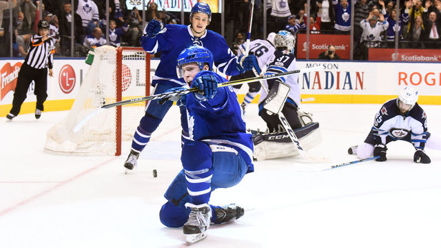 TORONTO, ON - FEBRUARY 21: Jake Gardiner #51 of the Toronto Maple Leafs celebrates his game winning overtime goal against Connor Hellebuyck #37 of the Winnipeg Jets with teammate William Nylander #29 at the Air Canada Centre on February 21, 2017 in Toronto, Ontario, Canada.