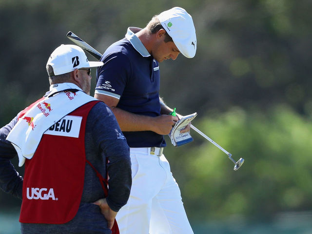 SOUTHAMPTON, NY - JUNE 14: Bryson DeChambeau of the United States waits on the fifth green with his caddie during the first round of the 2018 U.S. Open at Shinnecock Hills Golf Club on June 14, 2018 in Southampton, New York.