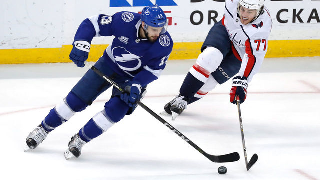TAMPA, FL - MAY 23: Cedric Paquette #13 of the Tampa Bay Lightning skates with the puck against T.J. Oshie #77 of the Washington Capitals during the first period in Game Seven of the Eastern Conference Finals during the 2018 NHL Stanley Cup Playoffs at Amalie Arena on May 23, 2018 in Tampa, Florida.