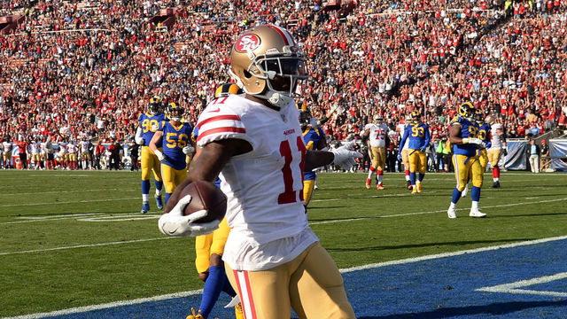 LOS ANGELES, CA - DECEMBER 31: Marquise Goodwin #11 of the San Francisco 49ers scores a touchdown during the first quarter against Brandon Allen #8 of the Los Angeles Rams at Los Angeles Memorial Coliseum on December 31, 2017 in Los Angeles, California.