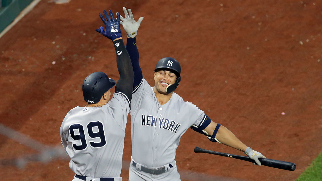 PHILADELPHIA, PA - JUNE 25: Aaron Judge #99 of the New York Yankees high-fives Giancarlo Stanton #27 after hitting a solo home run in the fifth inning during a game against the Philadelphia Phillies at Citizens Bank Park on June 25, 2018 in Philadelphia, Pennsylvania. The Yankees won 4-2.