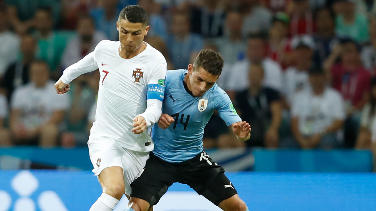 Uruguay's midfielder Lucas Torreira (R) vies for the ball with Portugal's forward Cristiano Ronaldo during the Russia 2018 World Cup round of 16 football match between Uruguay and Portugal at the Fisht Stadium in Sochi on June 30, 2018.