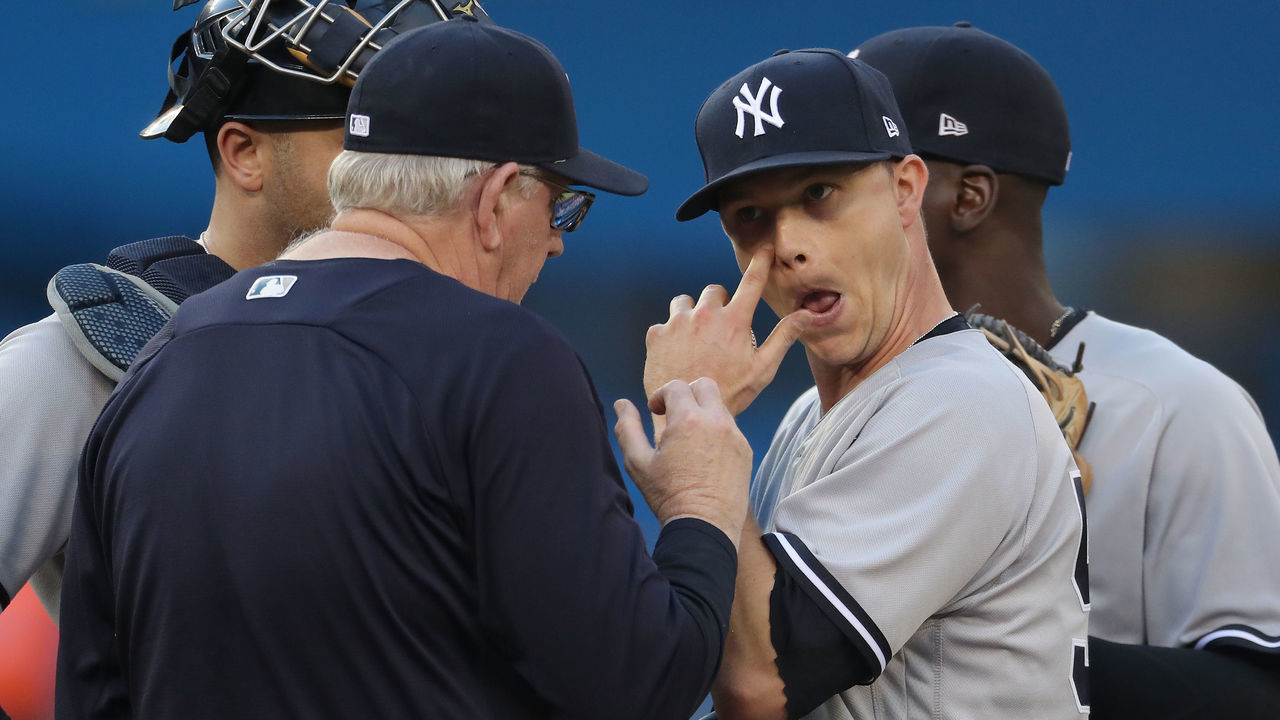 TORONTO, ON - JULY 6: Sonny Gray #55 of the New York Yankees is visited on the mound by pitching coach Larry Rothschild #58 in the second inning during MLB game action against the Toronto Blue Jays at Rogers Centre on July 6, 2018 in Toronto, Canada.