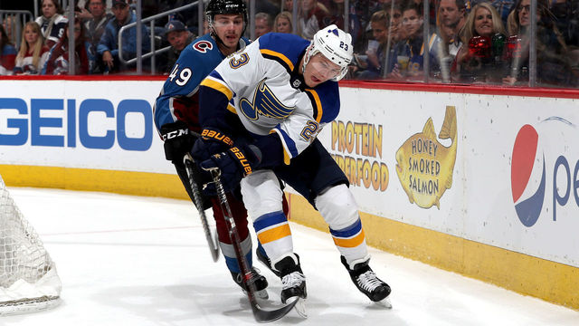 DENVER, CO - APRIL 07: Samuel Girard #49 of the Colorado Avalanche fights for control of the puck against Dmitrij Jaskin #23 of the St Louis Blues at the Pepsi Center on April 7, 2018 in Denver, Colorado.
