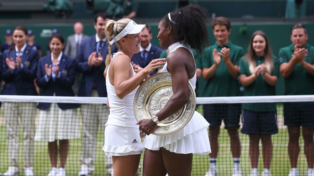 Winner US player Serena Williams (R), with the winner's trophy, the Venus Rosewater Dish, exchanges words with runner up Germany's Angelique Kerber (L) during the presentation after the women's singles final on the thirteenth day of the 2016 Wimbledon Championships at The All England Lawn Tennis Club in Wimbledon, southwest London, on July 9, 2016. / AFP / JUSTIN TALLIS / RESTRICTED TO EDITORIAL USE