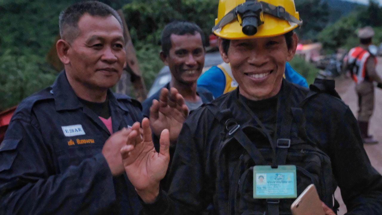 CHIANG RAI, THAILAND - JULY 8: Rescue workers along the main road leading to Tham Luang Nang Non cave as the first 2 ambulances carrying 2 boys pass by on July 8, 2018 in Chiang Rai, Thailand. Divers began an effort to pull the 12 boys and their soccer coach on Sunday morning after they were found alive in the cave at northern Thailand. Videos released by the Thai Navy SEAL shows the boys, aged 11 to 16, and their 25-year-old coach are in good health in Tham Luang Nang Non cave and the challenge now will be to extract the party safely.