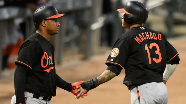 MINNEAPOLIS, MN - JULY 6: Jonathan Schoop #6 of the Baltimore Orioles congratulates teammate Manny Machado #13 on scoring a run against the Minnesota Twins during the sixth inning of the game on July 6, 2018 at Target Field in Minneapolis, Minnesota. The Twins defeated the Orioles 6-2.