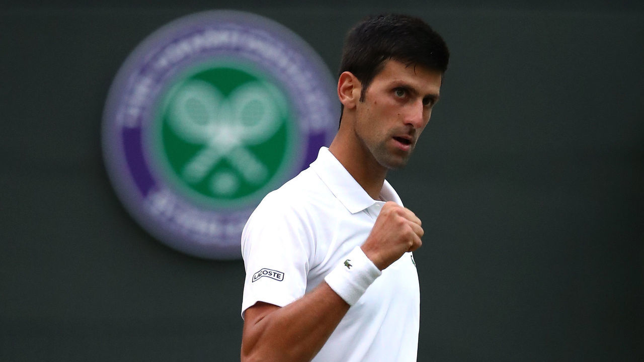 LONDON, ENGLAND - JULY 09: Novak Djokovic of Serbia celebrates match point against Karen Khachanov of Russia during their Men's Singles fourth round match on day seven of the Wimbledon Lawn Tennis Championships at All England Lawn Tennis and Croquet Club on July 9, 2018 in London, England.