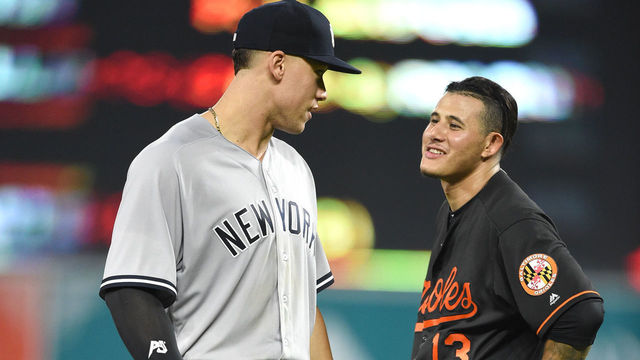 BALTIMORE, MD - JUNE 01: Aaron Judge #99 of the New York Yankees and Manny Machado #13 of the Baltimore Orioles talk between inning pitches during a baseball game at Oriole Park at Camden Yards on June 1, 2018 in Baltimore, Maryland.