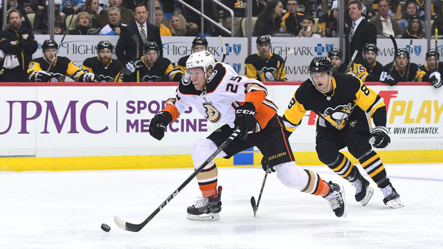 PITTSBURGH, PA - DECEMBER 23: Ondrej Kase #25 of the Anaheim Ducks skates with the puck while being defended by Brian Dumoulin #8 of the Pittsburgh Penguins at PPG PAINTS Arena on December 23, 2017 in Pittsburgh, Pennsylvania.