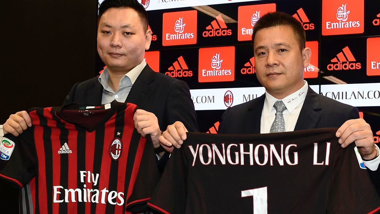 Head of Rossoneri Sport Investment Lux, Chinese businessman and new owner of the AC Milan football club, Yonghong Li (R) poses with Rossoneri Sport Investment Lux representative David Han Li (L) during a press conference on April 14, 2017 in Milan. Serie A giants AC Milan were sold to Rossoneri Sport Investment Lux yesterday in a deal which sees the Chinese-led consortium take a 99.9% stake in the club. The seven-time European champions who are Italy's most succcessful club in international competition, have been owned by former three-time Italy prime minister Silvio Berlusconi since 1986. A joint statement by AC Milan's holding company Fininvest and Rossoneri Sport Investment Lux said on April 13, 2017 : 'Today Fininvest has completed the sale of the entire stake owned in AC Milan - equal to 99.93% - to Rossoneri Sport Investment Lux.' / AFP PHOTO / MIGUEL MEDINA