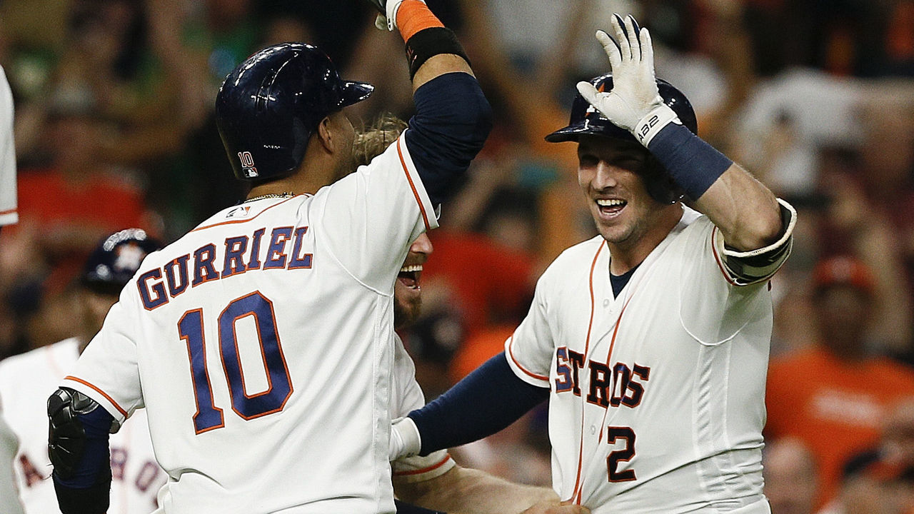 HOUSTON, TX - JULY 10: Alex Bregman #2 of the Houston Astros celebrates with Yuli Gurriel #10 after scoring in the eleventh inning to beat the Oakland Athletics at Minute Maid Park on July 10, 2018 in Houston, Texas.