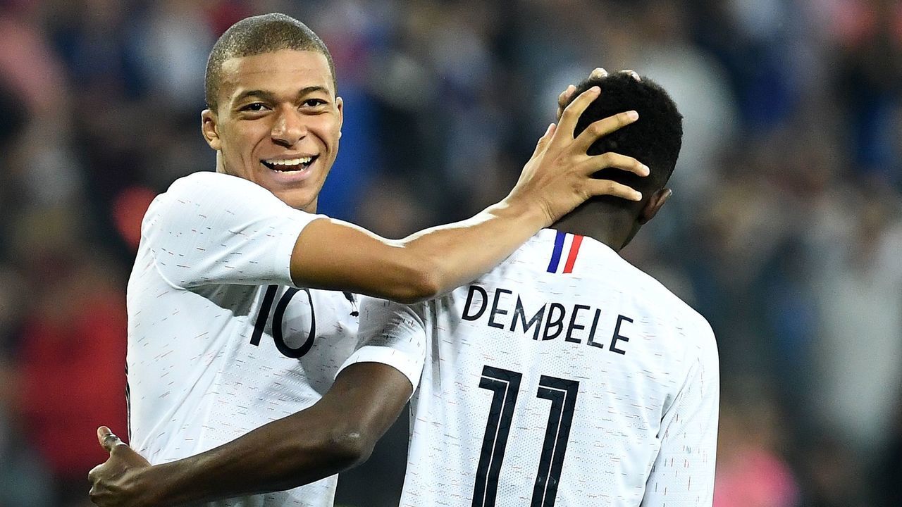 France's foward Kylian Mbappe (L) reacts with France's foward Ousmane Dembele during the friendly football match between France and Italy at the Allianz Riviera stadium in Nice, southeastern France on June 1, 2018.