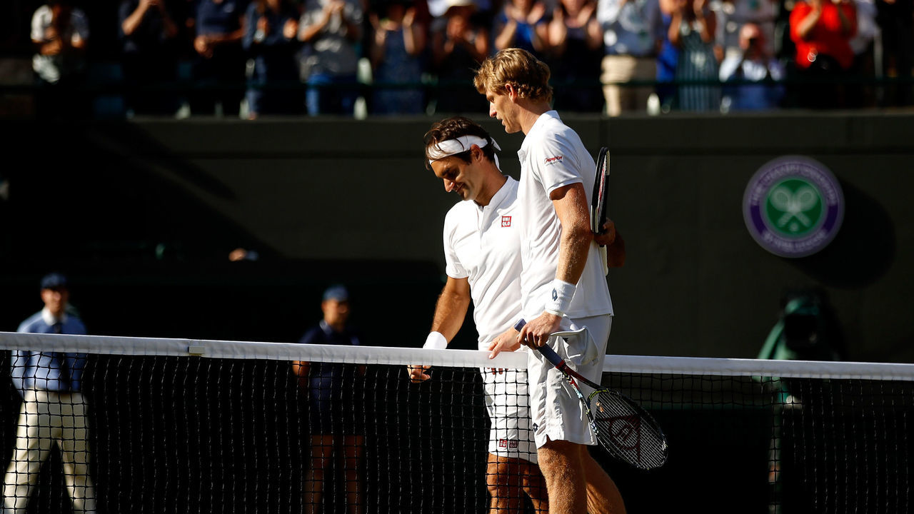 LONDON, ENGLAND - JULY 11: Kevin Anderson of South Africa and Roger Federer of Switzerland embrace at the net following their Men's Singles Quarter-Finals match on day nine of the Wimbledon Lawn Tennis Championships at All England Lawn Tennis and Croquet Club on July 11, 2018 in London, England. Anderson won the match 6-2, 7-6, 5-7, 4-6, 11-13 in 4hr 13min.
