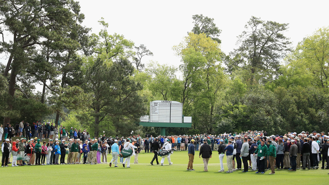 AUGUSTA, GA - APRIL 08: Phil Mickelson of the United States and Chez Reavie of the United States walk through the crowd on the fifth hole during the final round of the 2018 Masters Tournament at Augusta National Golf Club on April 8, 2018 in Augusta, Georgia.