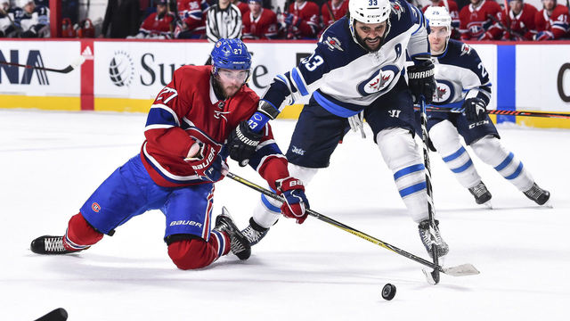 MONTREAL, QC - APRIL 03: Alex Galchenyuk #27 of the Montreal Canadiens and Dustin Byfuglien #33 of the Winnipeg Jets battle for the puck during the NHL game at the Bell Centre on April 3, 2018 in Montreal, Quebec, Canada.