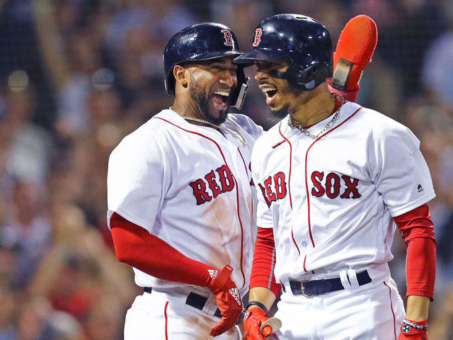 BOSTON, MA - JULY 12: Mookie Betts #50 of the Boston Red Sox celebrates with Eduardo Nunez #36 after hitting a grand slam against the Toronto Blue Jays during the fourth inning at Fenway Park on July 12, 2018 in Boston, Massachusetts.