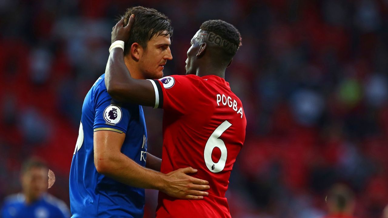 Manchester United's French midfielder Paul Pogba (R) and Leicester City's English defender Harry Maguire embrace on the pitch after the English Premier League football match between Manchester United and Leicester City at Old Trafford in Manchester, north west England, on August 26, 2017. Manchester United won the game 2-0. / AFP PHOTO / Geoff CADDICK /
