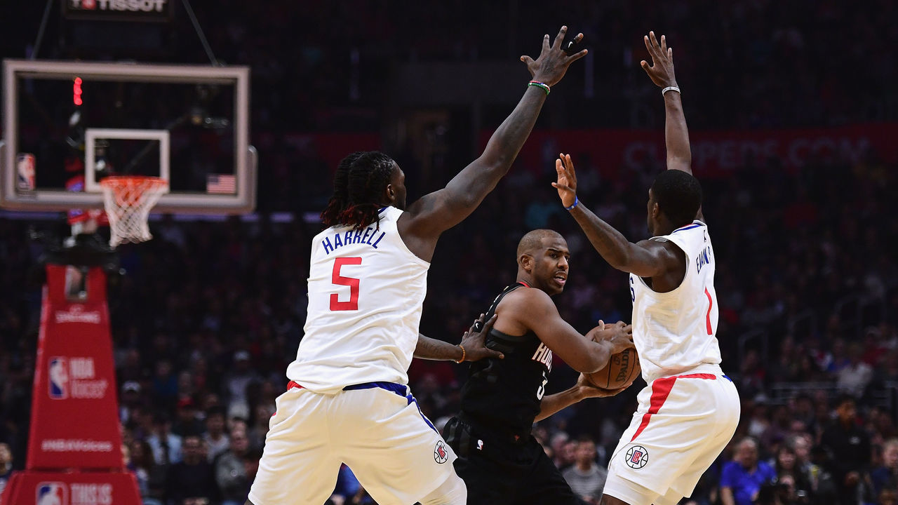 LOS ANGELES, CA - JANUARY 15: Chris Paul #3 of the Houston Rockets looks to pass between Montrezl Harrell #5 and Jawun Evans #1 of the LA Clippers during the first half at Staples Center on January 15, 2018 in Los Angeles, California.
